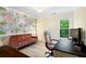 Home office featuring floral wallpaper, a comfortable couch, and a sleek black desk at 681 Braidwood Nw Ter, Acworth, GA 30101