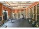Unfinished basement set up as a gym with workout equipment and exposed ceiling at 8090 Tristan Way, Whitesburg, GA 30185