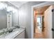 Well-lit bathroom with a marble countertop and modern fixtures at 8090 Tristan Way, Whitesburg, GA 30185