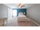 Cozy bedroom featuring a floral bedspread, carpet, and blue accent wall at 8090 Tristan Way, Whitesburg, GA 30185