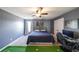 Bedroom with grey walls, a ceiling fan, carpet, and a decorative putting green at 8090 Tristan Way, Whitesburg, GA 30185