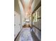 Warm and welcoming foyer with hardwood floors, an elegant rug, and high ceilings at 8090 Tristan Way, Whitesburg, GA 30185