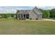 Charming single-story home with stone accents, a covered front porch, and a large, well-manicured lawn at 8090 Tristan Way, Whitesburg, GA 30185