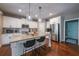 Modern kitchen featuring stainless steel appliances, granite countertops, and a convenient breakfast bar at 8090 Tristan Way, Whitesburg, GA 30185