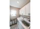 Bright laundry room featuring white cabinets and modern appliances at 8090 Tristan Way, Whitesburg, GA 30185
