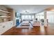 Spacious living room featuring hardwood floors, a fireplace, built-in shelving, and lots of natural light at 8090 Tristan Way, Whitesburg, GA 30185