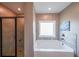Modern main bathroom with tile shower, soaking tub and large window for plenty of natural light at 8090 Tristan Way, Whitesburg, GA 30185