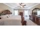 Spacious main bedroom features a tray ceiling, ceiling fan, neutral carpet and large windows at 8090 Tristan Way, Whitesburg, GA 30185