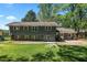 Expansive backyard with mature trees and a patio for outdoor dining and entertaining at 1954 Timothy Dr, Atlanta, GA 30329