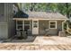Backyard with patio, table, grill, and mature trees creating a private outdoor space at 1954 Timothy Dr, Atlanta, GA 30329