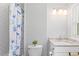 Bright bathroom showcasing tiled shower with starfish curtain and granite vanity at 1954 Timothy Dr, Atlanta, GA 30329
