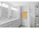 Bright bathroom showcasing dual sink granite vanity and tiled shower with glass door at 1954 Timothy Dr, Atlanta, GA 30329