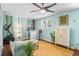 Cozy living room with a bar, exercise equipment, colorful artwork, and a stylish ceiling fan at 1954 Timothy Dr, Atlanta, GA 30329