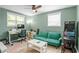 Home office setup with green sofa, desk, computer, and a classic arcade game at 1954 Timothy Dr, Atlanta, GA 30329