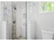 Tiled shower with glass door showcasing pebble floor at 1954 Timothy Dr, Atlanta, GA 30329