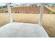 View of back yard and patio with young grass at 3355 Hillshire Dr, Cumming, GA 30028