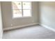 Cozy bedroom with plush gray carpeting and a large window offering serene views at 3355 Hillshire Dr, Cumming, GA 30028