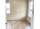 Bright bedroom with modern horizontal shiplap accent wall and ample natural light through two windows at 3355 Hillshire Dr, Cumming, GA 30028