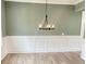 Dining room featuring wainscoting, a modern chandelier, and ample space for entertaining at 3355 Hillshire Dr, Cumming, GA 30028
