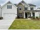 Charming two-story home featuring a brick facade, white siding, and a well-manicured lawn at 3355 Hillshire Dr, Cumming, GA 30028