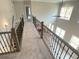 Hallway with wood railings and view to great room at 3355 Hillshire Dr, Cumming, GA 30028
