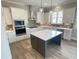 Modern kitchen featuring white cabinetry, stainless steel appliances, and a kitchen island at 3355 Hillshire Dr, Cumming, GA 30028