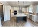 Gourmet kitchen with stainless steel appliances, white cabinets, and a large island at 3355 Hillshire Dr, Cumming, GA 30028