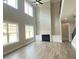 Bright living room showcasing a fireplace, built-in cabinets, large windows and soaring ceilings at 3355 Hillshire Dr, Cumming, GA 30028