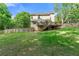Level backyard with grass lawn, wood fence, mature trees and view of deck and rear of house at 706 Briarleigh Sw Ct, Mableton, GA 30126