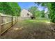 Large backyard with a wood fence, grass lawn, some patchy spots and a view of the house at 706 Briarleigh Sw Ct, Mableton, GA 30126