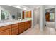 Bathroom featuring double vanity, wood cabinets, and neutral tile flooring at 706 Briarleigh Sw Ct, Mableton, GA 30126
