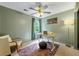 Bedroom featuring a ceiling fan, a window, and a desk with a laptop on top at 706 Briarleigh Sw Ct, Mableton, GA 30126