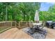 Wooden deck with outdoor dining and mature trees at 706 Briarleigh Sw Ct, Mableton, GA 30126