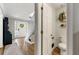 Stylish half-bathroom adjacent to the foyer with wood floors and decor at 706 Briarleigh Sw Ct, Mableton, GA 30126