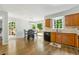 Kitchen and dining area with wooden cabinets, modern light fixtures and access to a large wooden deck at 706 Briarleigh Sw Ct, Mableton, GA 30126