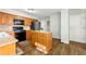 Cozy kitchen area complete with wood cabinets, stainless steel appliances, and a centered island with light granite countertops at 706 Briarleigh Sw Ct, Mableton, GA 30126