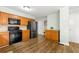 Kitchen with stainless steel appliances, wood cabinets, granite countertops and dark brown floors at 706 Briarleigh Sw Ct, Mableton, GA 30126
