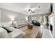 Inviting living room with plush seating, a cozy fireplace, and an area rug on hardwood floors at 706 Briarleigh Sw Ct, Mableton, GA 30126
