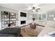 Bright living room with fireplace, ceiling fan, decorative shelves and large rug at 706 Briarleigh Sw Ct, Mableton, GA 30126