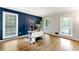 Bright home office with accent wall, wood floors, and multiple windows at 706 Briarleigh Sw Ct, Mableton, GA 30126