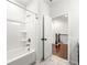 Bright bathroom with a shower-tub combo and an entrance that overlooks hardwood floors and stairwell at 4325 Water Elm Aly, Doraville, GA 30360