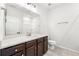 Bathroom featuring vanity with white countertop, dark wood cabinets, and neutral color palette at 4325 Water Elm Aly, Doraville, GA 30360
