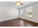 Bedroom featuring two large windows, ceiling fan, hardwood floors, and neutral walls at 4325 Water Elm Aly, Doraville, GA 30360