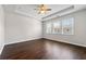 Bright bedroom featuring hardwood floors, ceiling fan, tray ceiling, and large windows at 4325 Water Elm Aly, Doraville, GA 30360