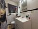 Well-maintained bathroom with a modern vanity, a decorative shower curtain, and good lighting at 944 Stallings Se Ave, Atlanta, GA 30316