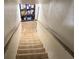 Carpeted stairs leading to a basement, with handrails on both sides and a shelf at the top at 944 Stallings Se Ave, Atlanta, GA 30316