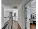 Upstairs hallway featuring hardwood floors, white trim, and neutral walls leading to bedrooms at 10783 Glenleigh Dr, Duluth, GA 30097