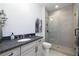 Modern bathroom featuring a glass-enclosed shower and sleek vanity with granite countertop at 301 Sobeck Way, Canton, GA 30115