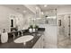 Bathroom featuring a marble shower and dark countertop with white cabinets and dark hardware at 301 Sobeck Way, Canton, GA 30115