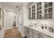 Butler's pantry features glass-front cabinets, a countertop, and hardwood floors at 301 Sobeck Way, Canton, GA 30115